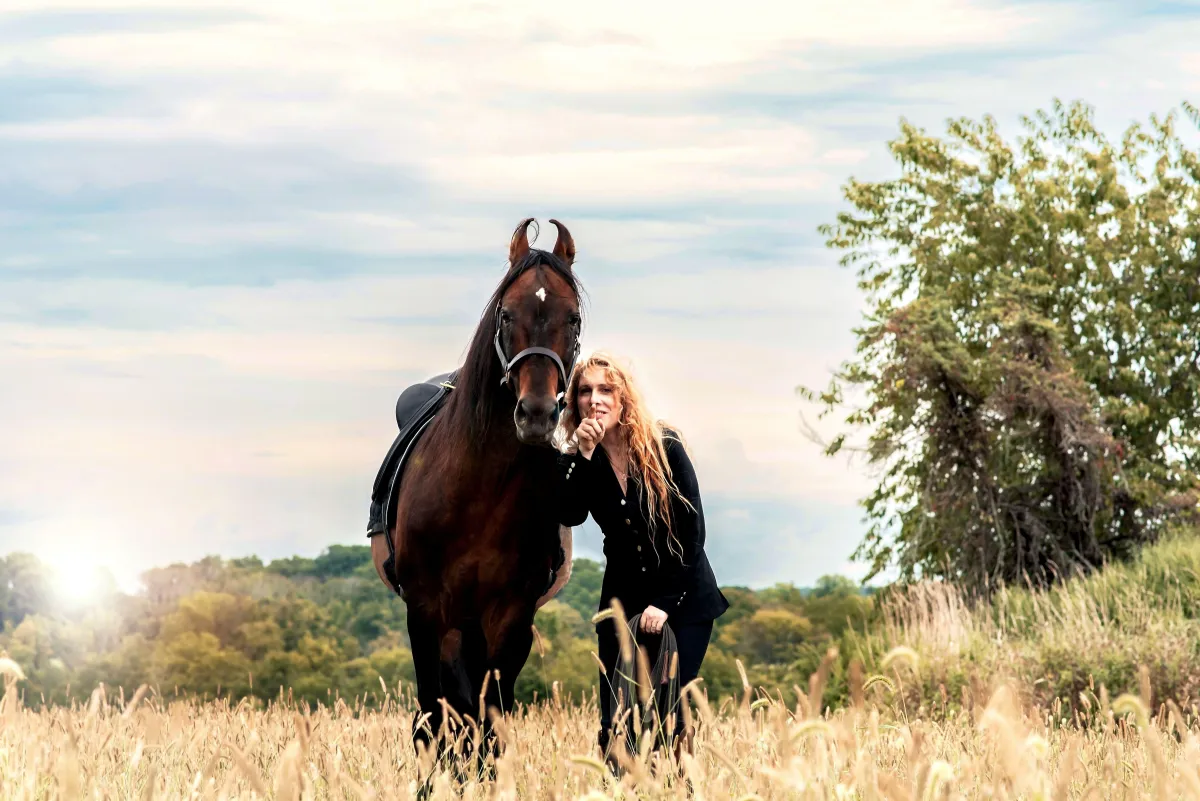 Rider forming a bond with horse in field